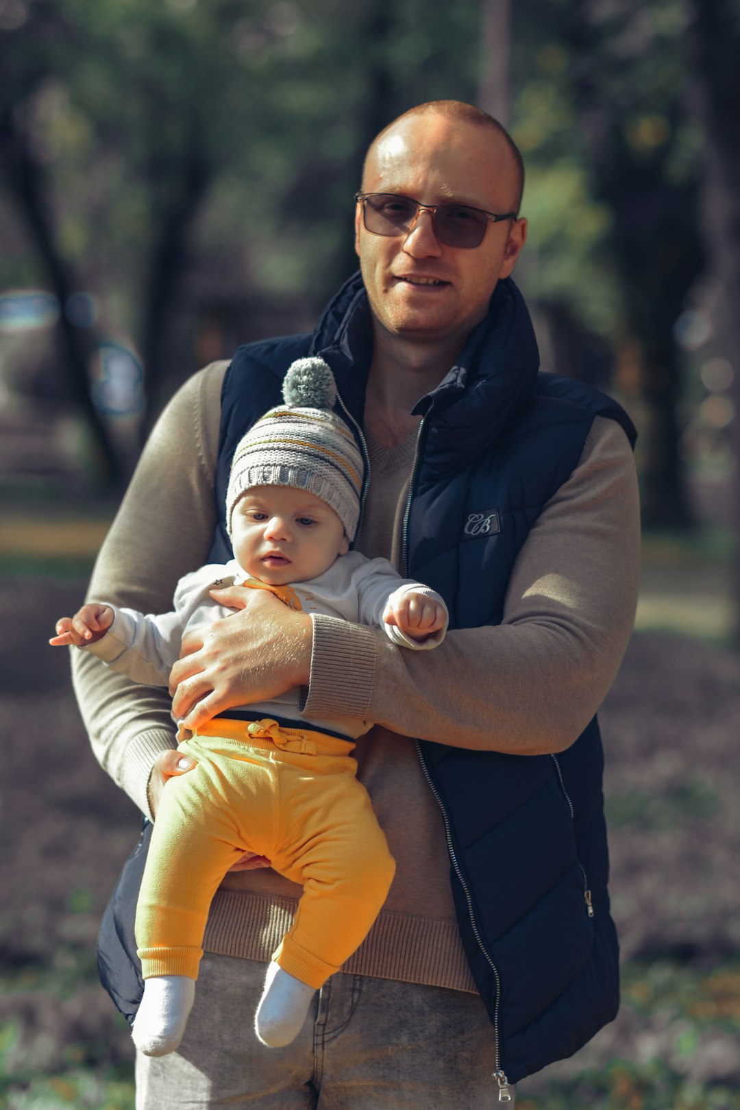 Father gently holding and looking at his baby