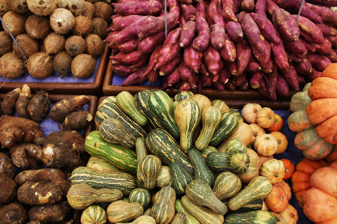 Variety of fresh vegetables and gourds at a market.