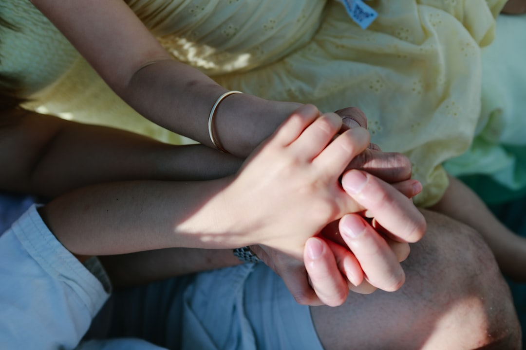 Two people holding hands in sunlight